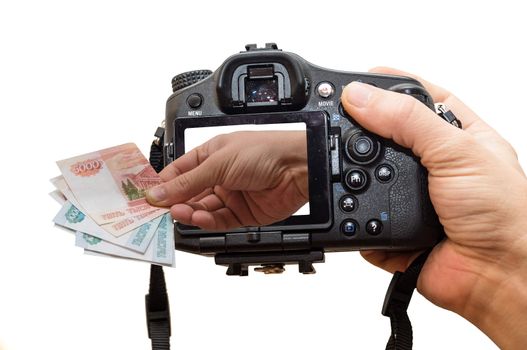 The photo depicts a camera and a hand full of money