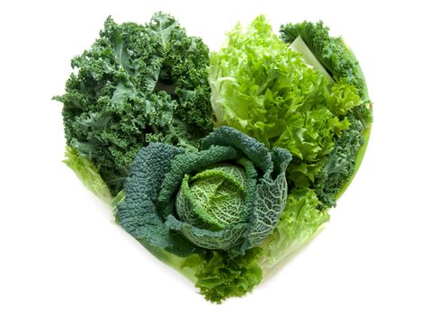 Green healthy vegetables in the shape of a heart isolated over a white background