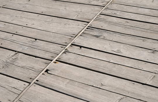 Old vintage rustic aged antique wooden sepia panel with diagonal gaps, planks and chinks