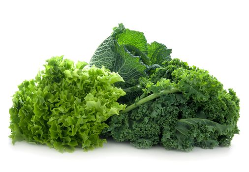 Healthy green detox vegetables including kale, cabbge and lettuce isolated on a white background