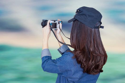 woman traveler wearing blue dress as photographer, take photo with camera outdoor