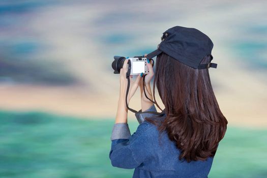 woman traveler wearing blue dress as photographer, take photo with camera outdoor