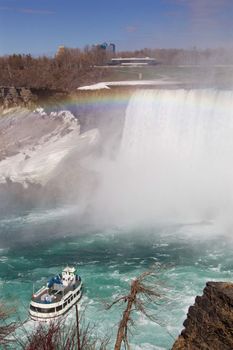 Very beautiful background of the Niagara falls, rainbow and a white ship