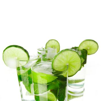 Mojito cocktails with lime and mint isolated on white background