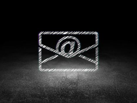 Business concept: Glowing Email icon in grunge dark room with Dirty Floor, black background