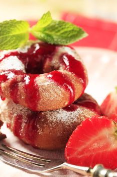 Ring donuts with strawberry syrup