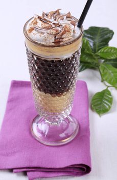 Liqueur coffee with whipped cream and chocolate sauce