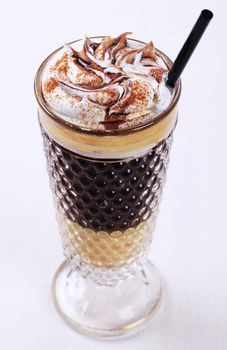 Liqueur coffee with whipped cream and chocolate sauce