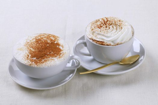 Cups of cappuccino and Vienna coffee