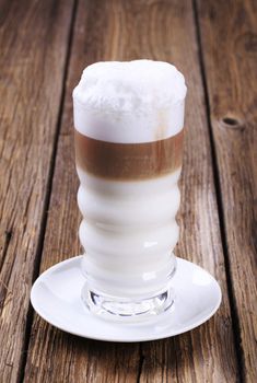 Glass of Latte macchiato with milk foam 