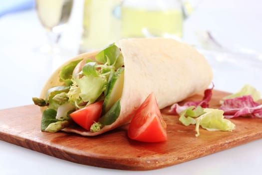 Corn tortilla filled with fresh vegetable salad 