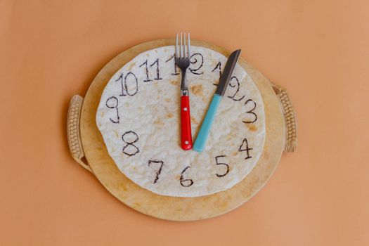 a white piadina forms a clock  with red and green hands remember that is an italian  product