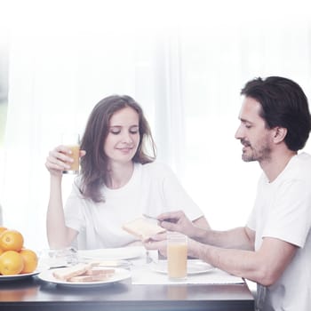 Couple having breakfast together at home 