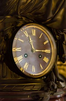 detail of antique table clock with manual winding