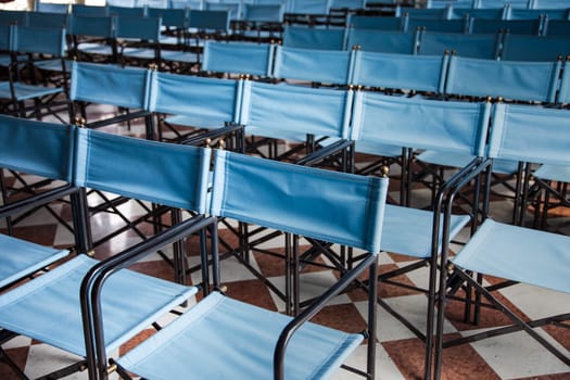 composition of blue canvas folding chairs empty