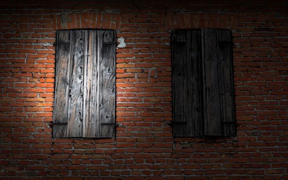 Window on red brick wall illuminated by a flashlight.