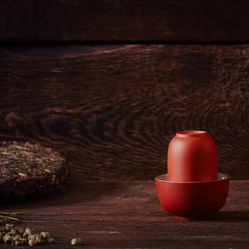 Ceramic tea cup, loose tea leaf on wood table