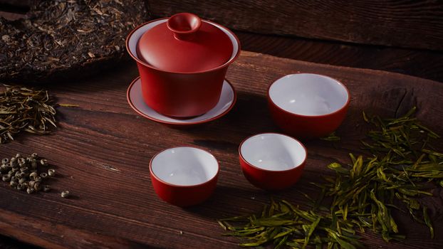 Ceramic tea cup, loose tea leaf on wood table