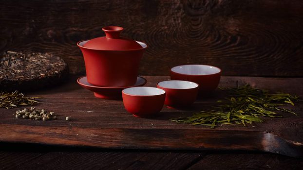 Ceramic tea cup, loose tea leaf on wood table