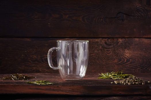 Thermo tea cup, loose tea leaf on wood table