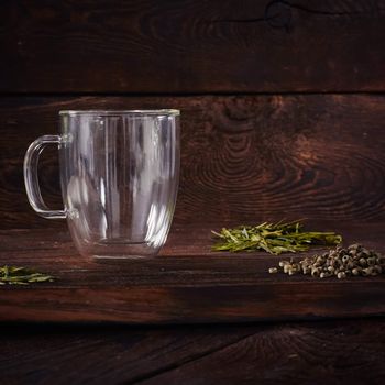 Thermo tea cup, loose tea leaf on wood table