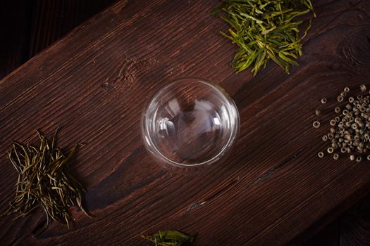 Thermo tea cup, loose tea leaf on wood table
