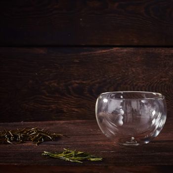 Thermo tea cup, loose tea leaf on wood table