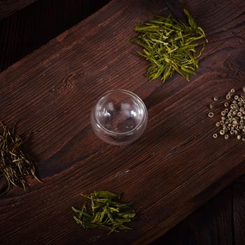 Thermo tea cup, loose tea leaf on wood table