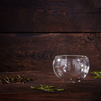 Thermo tea cup, loose tea leaf on wood table