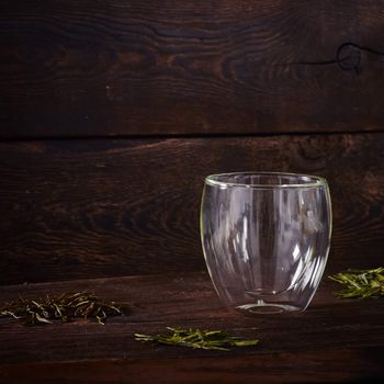 Thermo tea cup, loose tea leaf on wood table