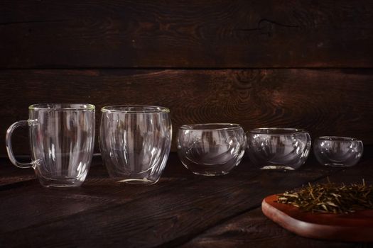 Thermo tea cup, loose tea leaf on wood table