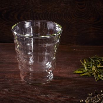 Thermo tea cup, loose tea leaf on wood table