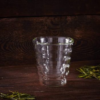 Thermo tea cup, loose tea leaf on wood table