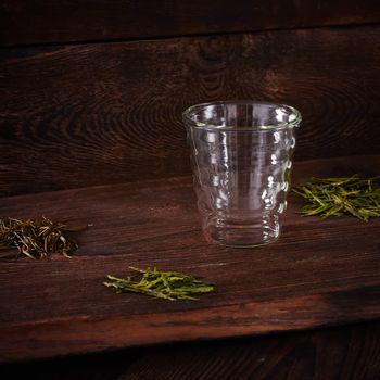 Thermo tea cup, loose tea leaf on wood table