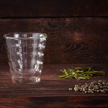 Thermo tea cup, loose tea leaf on wood table