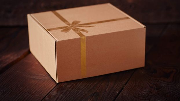 Carton Gift Box on the dark wood background