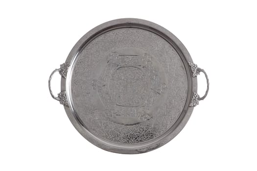 Embossed round silver coffee tray with a decorative floral pattern and handles viewed overhead isolated on white