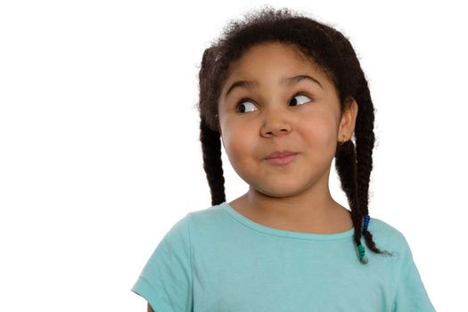 Charismatic little African American girl looking sideways with a cute knowing smile and speculative look, head and shoulders isolated on white with lateral copyspace