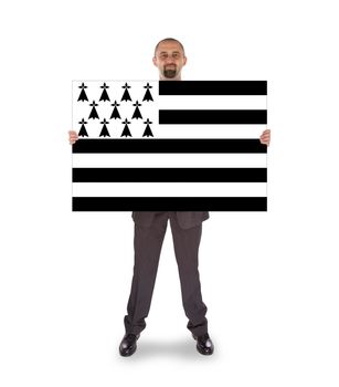Smiling businessman holding a big card, flag of Brittany, isolated on white