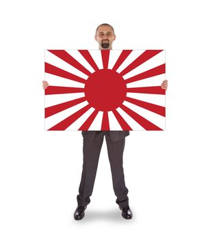 Smiling businessman holding a big card, flag of Japan, isolated on white