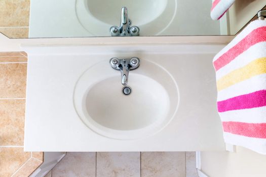 Above view of classical Clean domestic sink with faucet and towel