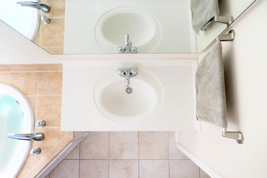 Overhead View of Classical Acrylic Top Sink along with a full bathtub and faucets