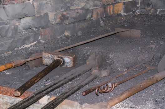 Tools such as hammer, pliers in an old forge.