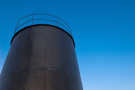 crude oil storage tank with blue sky