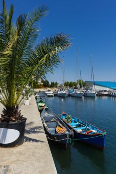 Old wooden fisherman boats docked in the Tomis touristic harbor in Constanta Romania