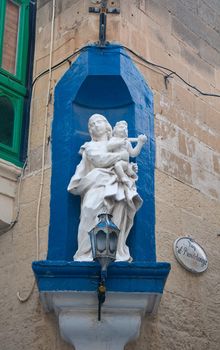 Statue of the Madonna with her child in a street in Malta