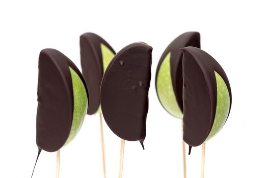 Chocolate dipped apple fruit on a white background