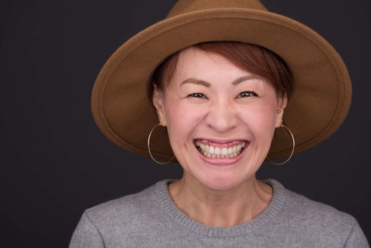 A headshot of a smiling middle aged Japanese woman.