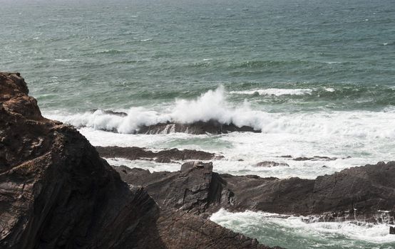 water splashing on the rocks at the atlantic ocean