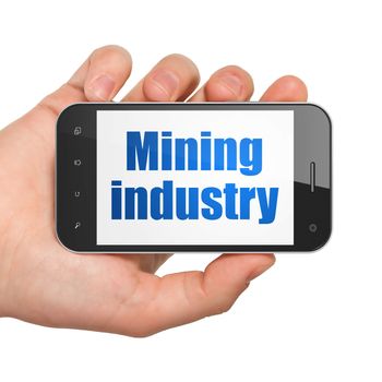 Industry concept: Hand Holding Smartphone with  blue text Mining Industry on display,  Tag Cloud background